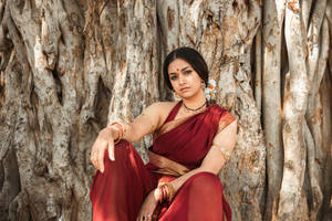 Captivating Keerthi Suresh In Elegant Saree Against An Enchanting Background Wallpaper