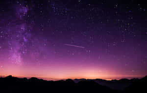 Captivating Meteor Shower In The Night Sky Wallpaper