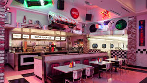 Captivating Pink 50s Diner Interior View Wallpaper