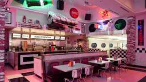Captivating Pink 50s Diner Interior View Wallpaper