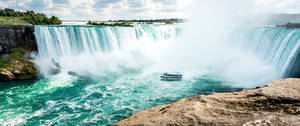 Captivating Thrill Of The Maid Of The Mist At Niagara Falls Wallpaper