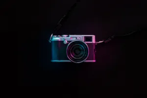 Capture The Magic Of Life With A Black And Silver Slr Camera Wallpaper