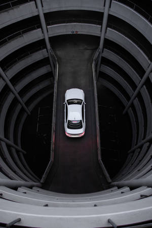 Car Driving In Round Car Parking Lot Wallpaper