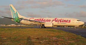 Caribbean Airlines Plane On Runway Grasslands Wallpaper