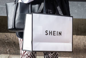 Carrying A Shein Paper Bag Wallpaper