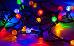 Celebrate The Holidays With Stunning Round Christmas Lights Wallpaper