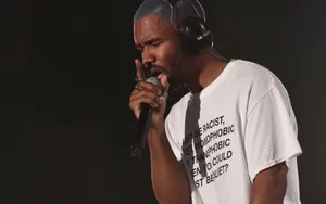 Celebrity Rapper Frank Ocean Working On His Laptop Wallpaper