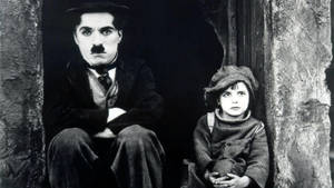 Charlie Chaplin Playing With A Child Wallpaper