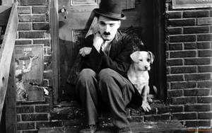 Charlie Chaplin Strikes A Pose With A Lucky Pup. Wallpaper