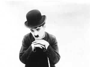 Charlie Chaplin, The Tramp, Wears His Trademark Forlorn Expression Wallpaper