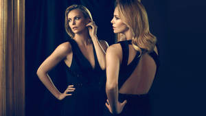 Charlize Theron Stuns In A Sleek Black Dress Wallpaper