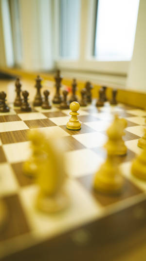 Chess Pieces On Checkered Board Wallpaper