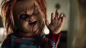 Child's Play Waving Chucky Wallpaper