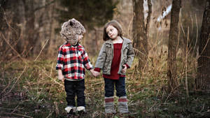 Children Holding Hands In The Wilderness Wallpaper