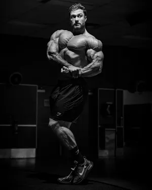 Chris Bumstead With Side Chest Pose Wallpaper