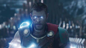 Chris Hemsworth's Intense Gaze With Glowing Blue Eyes. Wallpaper