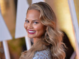 Chrissy Teigen Red Carpet Smile Wallpaper