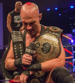 Christopher Daniels Triumphantly Holding The Roh Championship Belt Wallpaper