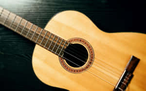 Classic Acoustic Guitaron Dark Background.jpg Wallpaper