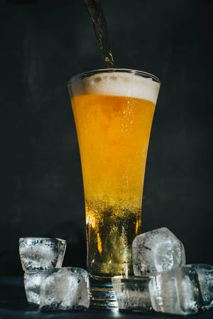 Clear Drinking Glass With Beer Wallpaper