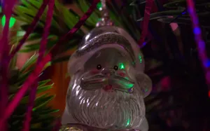 Clear Glass Bird Ornament On Green Christmas Tree Wallpaper