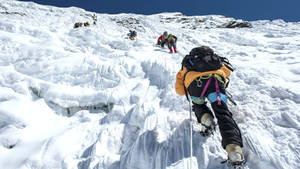 Climbing Group Trailing One Another Wallpaper