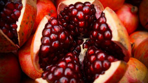 Close-up Photo Of Sliced Pomegranate Wallpaper