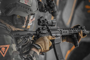 Close-up Photography Of Person Holding Rifle Wallpaper