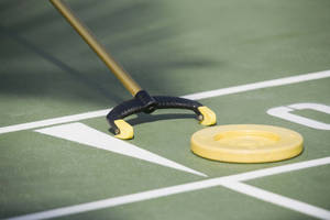 Close-up Shot Shuffleboard Disc And Cue Wallpaper