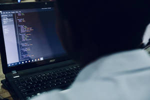 Coder Staring At Laptop Wallpaper