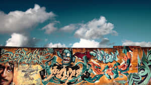 Colorful Graffiti Mural On Berlin Wall And Blue Skies Wallpaper