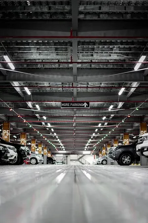 Contemporary Metal Building Of A Car Parking Lot Wallpaper