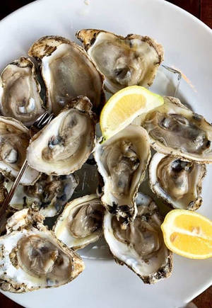 Cooked Oyster On Plate With Lemon Wallpaper