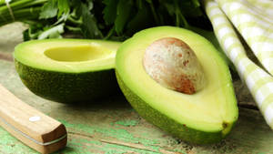 Cool Avocado Fruit Slice Display Wallpaper