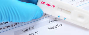 Covid Test Gloved Hand Holding Result Wallpaper