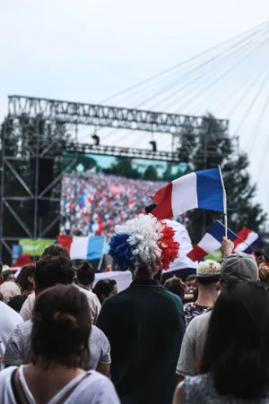 Crowd Of People Gathered Around Stage During Daytime Wallpaper