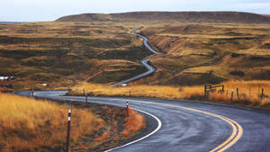 Curvy Road On Grassland Wallpaper