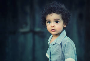 Cute Baby With Black Curly Hair Wallpaper