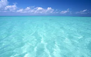 Cyan Ocean Cloudy Sky Wallpaper