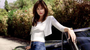 Dakota Johnson Fancy Car Wallpaper