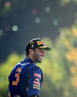 Daniel Ricciardo Gazes Off To The Side On The Race Track Wallpaper