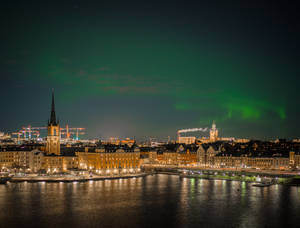 Dark Green Northern Lights In The City Wallpaper