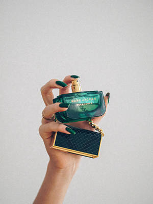 Dark Green Perfume In Hand Wallpaper