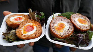 Delectable British Scotch Eggs Topped With Mouth-watering Vegetables Wallpaper