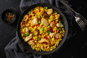 Delectable Seafood Paella With Vibrant Yellow Rice Wallpaper