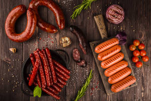 Delicious Assortment Of Grilled Sausages Wallpaper