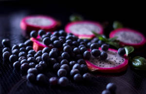 Delicious Huckleberry With Dragon Fruit Slices Wallpaper