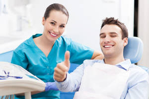 Dentist Smiling With Patient Wallpaper