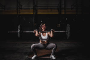 Determined Woman Mastering The Barbell Wallpaper