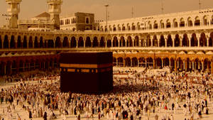 Devout Muslims Engaged In Prayer At The Sacred Kaaba Wallpaper